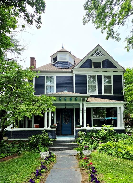 615 N Jefferson St, Carrollton, MO 64633 - victorian-style house with covered porch and a chimney