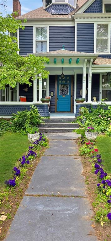 615 N Jefferson St, Carrollton, MO 64633 - property entrance featuring a chimney and covered porch