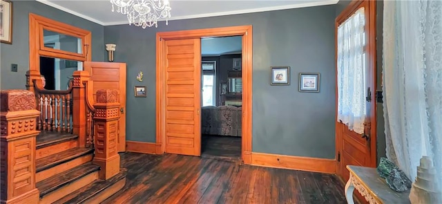 615 N Jefferson St, Carrollton, MO 64633 - entryway with dark wood-style flooring, a chandelier, crown molding, and stairway
