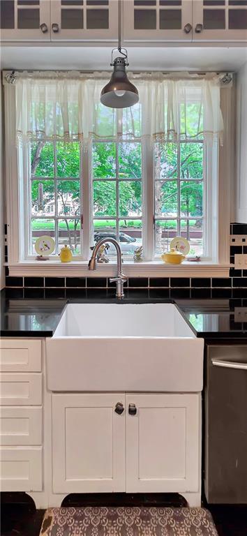 615 N Jefferson St, Carrollton, MO 64633 - kitchen featuring dark countertops, white cabinetry, and healthy amount of natural light