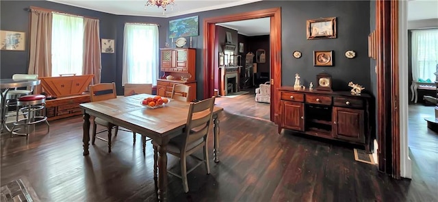 615 N Jefferson St, Carrollton, MO 64633 - dining space featuring dark wood-style floors, healthy amount of natural light, and ornamental molding