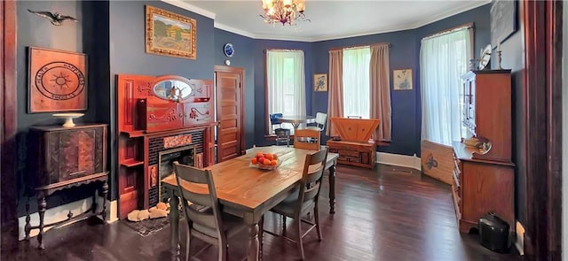 615 N Jefferson St, Carrollton, MO 64633 - dining space featuring ornamental molding, a fireplace, a chandelier, and dark wood finished floors
