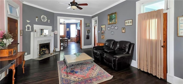 615 N Jefferson St, Carrollton, MO 64633 - living area featuring a ceiling fan, dark wood-style floors, ornamental molding, and a fireplace