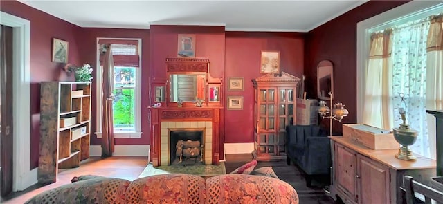 615 N Jefferson St, Carrollton, MO 64633 - sitting room with a fireplace, wood finished floors, and ornamental molding