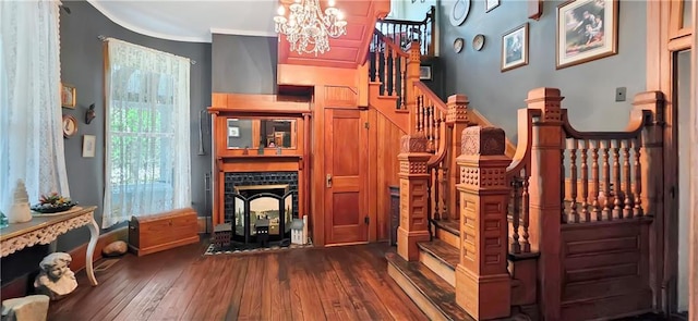 615 N Jefferson St, Carrollton, MO 64633 - interior space featuring stairway, dark wood-style floors, a chandelier, and crown molding