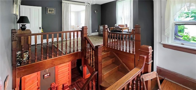 615 N Jefferson St, Carrollton, MO 64633 - stairs featuring wood finished floors and a chandelier