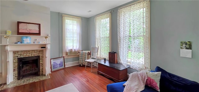 615 N Jefferson St, Carrollton, MO 64633 - sitting room with wood finished floors and a fireplace with flush hearth