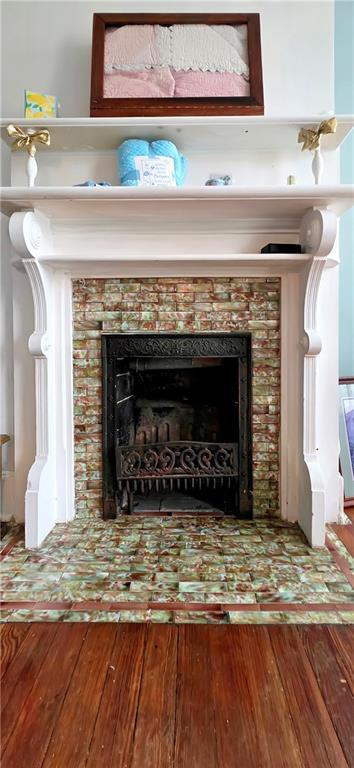 615 N Jefferson St, Carrollton, MO 64633 - detailed view of wood finished floors and a tile fireplace