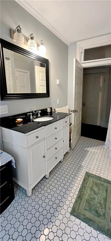 615 N Jefferson St, Carrollton, MO 64633 - bathroom featuring ornamental molding and vanity