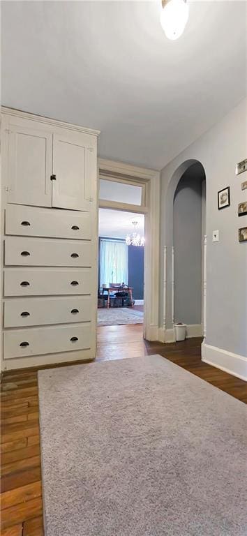 615 N Jefferson St, Carrollton, MO 64633 - corridor with arched walkways and dark wood finished floors