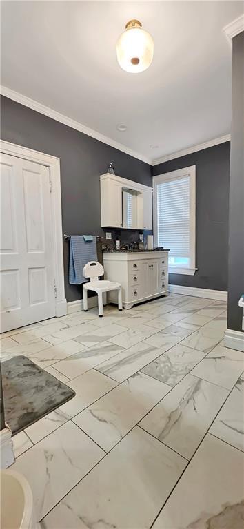 615 N Jefferson St, Carrollton, MO 64633 - bathroom with crown molding, vanity, and marble finish floors