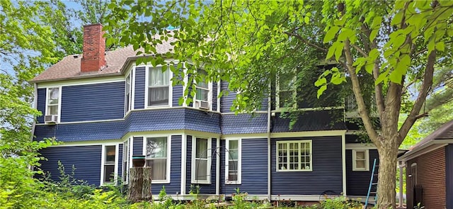 615 N Jefferson St, Carrollton, MO 64633 - rear view of property featuring a chimney