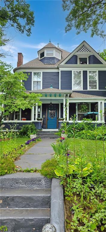 615 N Jefferson St, Carrollton, MO 64633 - victorian house with covered porch and a chimney