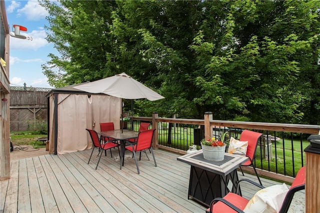 117 Ellison Way, Independence, MO 64050 - wooden terrace with outdoor dining space and a storage shed