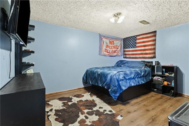 117 Ellison Way, Independence, MO 64050 - bedroom with wood finished floors and a textured ceiling