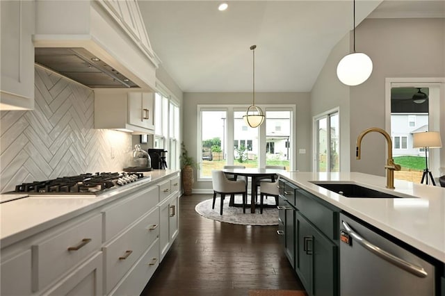 144 SE Riley St, Blue Springs, MO 64064 - kitchen featuring appliances with stainless steel finishes, light countertops, decorative backsplash, lofted ceiling, and decorative light fixtures