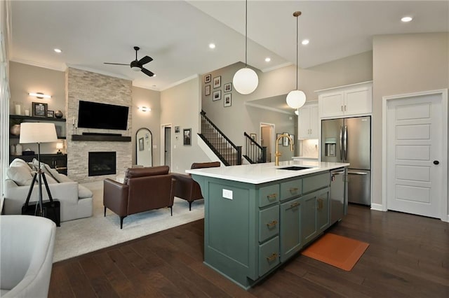 144 SE Riley St, Blue Springs, MO 64064 - kitchen with open floor plan, green cabinetry, appliances with stainless steel finishes, ceiling fan, and ornamental molding