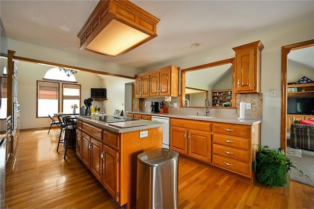 23800 Lucille Ln, Peculiar, MO 64078 - kitchen with black electric cooktop, dishwasher, a center island, wood finished floors, and backsplash