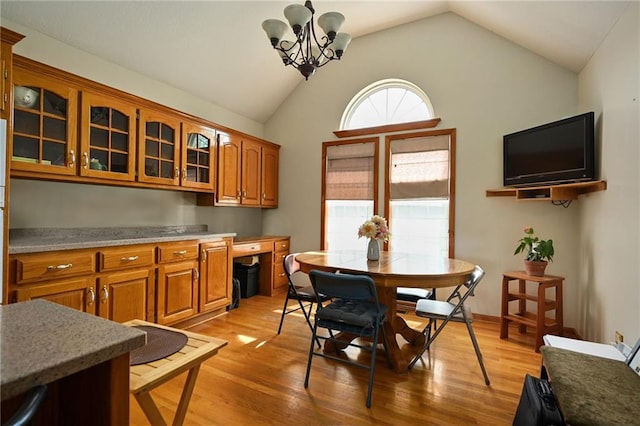 23800 Lucille Ln, Peculiar, MO 64078 - dining space with light wood finished floors, vaulted ceiling, and a chandelier