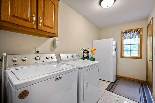 23800 Lucille Ln, Peculiar, MO 64078 - laundry room featuring cabinet space, washing machine and dryer, and light tile patterned floors