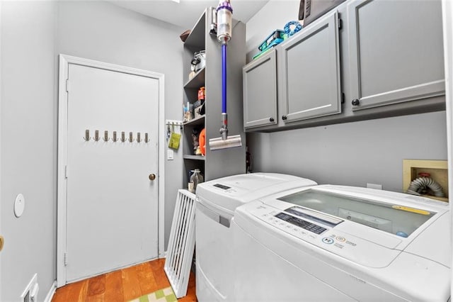 24137 W 57th Ter, Shawnee, KS 66226 - washroom featuring separate washer and dryer, cabinet space, and light wood finished floors