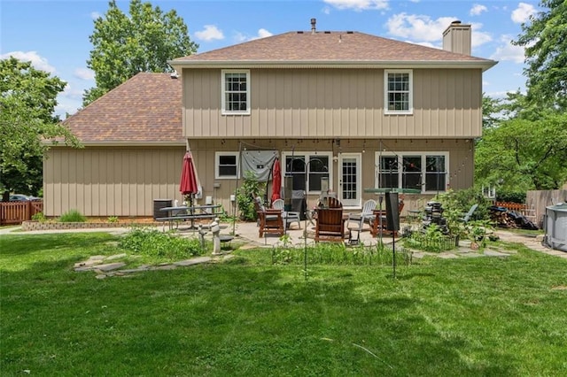 24137 W 57th Ter, Shawnee, KS 66226 - rear view of house with a chimney, a patio area, and a shingled roof