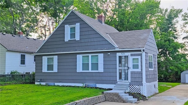 4216 E 67th Ter, Kansas City, MO 64132 - bungalow-style house featuring entry steps, a chimney, crawl space, and roof with shingles