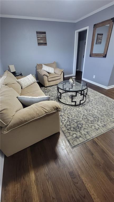 4216 E 67th Ter, Kansas City, MO 64132 - living area featuring dark wood finished floors and crown molding