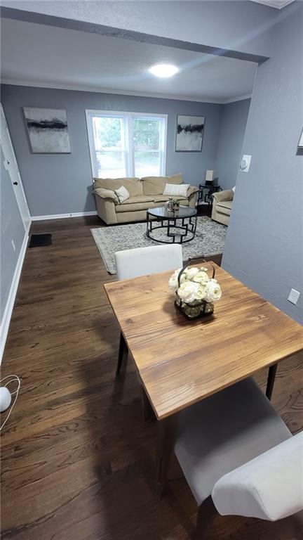 4216 E 67th Ter, Kansas City, MO 64132 - dining room featuring dark wood-type flooring