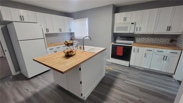 4216 E 67th Ter, Kansas City, MO 64132 - kitchen featuring wood counters, white appliances, dark wood-type flooring, tasteful backsplash, and white cabinetry