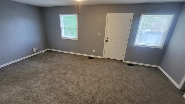 4216 E 67th Ter, Kansas City, MO 64132 - spare room featuring dark carpet and baseboards