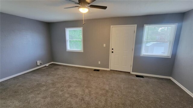 4216 E 67th Ter, Kansas City, MO 64132 - carpeted spare room with a ceiling fan and baseboards