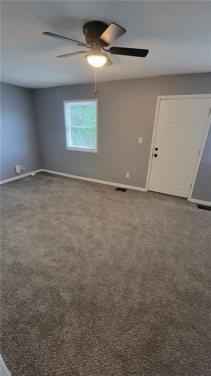 4216 E 67th Ter, Kansas City, MO 64132 - carpeted empty room with a ceiling fan and baseboards