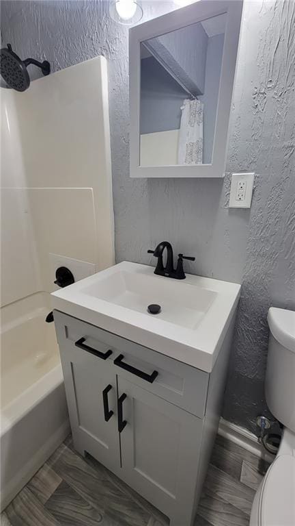 4216 E 67th Ter, Kansas City, MO 64132 - full bath with a textured wall, vanity, and shower / bath combo