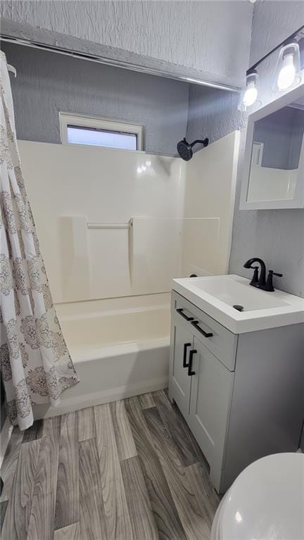 4216 E 67th Ter, Kansas City, MO 64132 - bathroom featuring vanity, shower / tub combo, and wood finished floors
