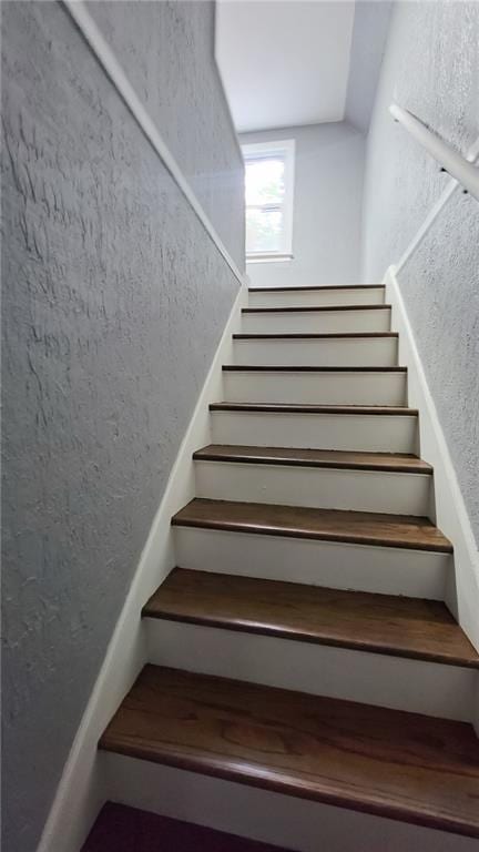 4216 E 67th Ter, Kansas City, MO 64132 - stairs featuring a textured wall and lofted ceiling