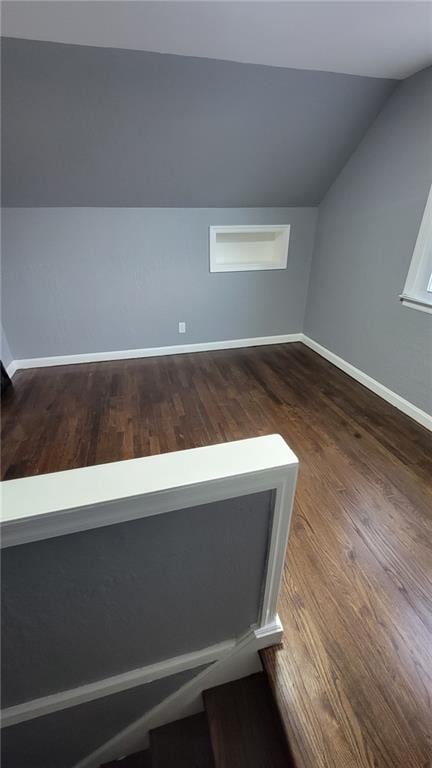 4216 E 67th Ter, Kansas City, MO 64132 - bonus room featuring vaulted ceiling and dark wood-style floors