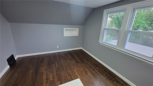 4216 E 67th Ter, Kansas City, MO 64132 - bonus room featuring vaulted ceiling and dark wood-style floors
