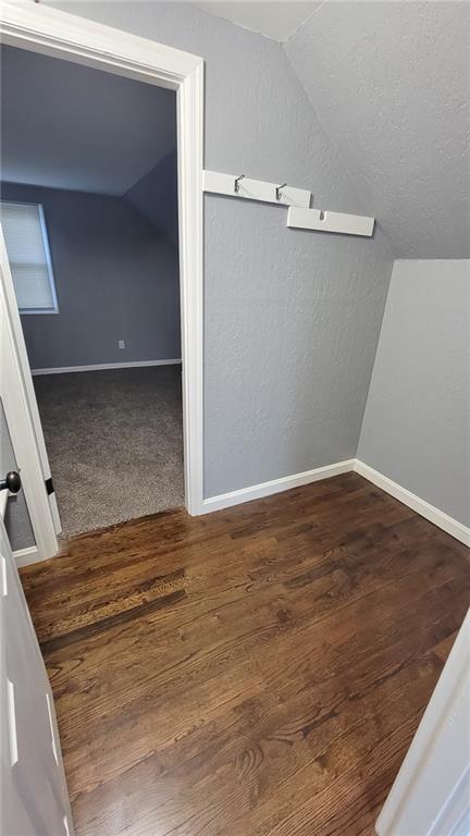 4216 E 67th Ter, Kansas City, MO 64132 - bonus room featuring vaulted ceiling and wood finished floors