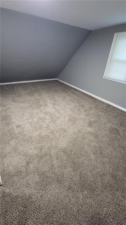 4216 E 67th Ter, Kansas City, MO 64132 - bonus room featuring vaulted ceiling and carpet
