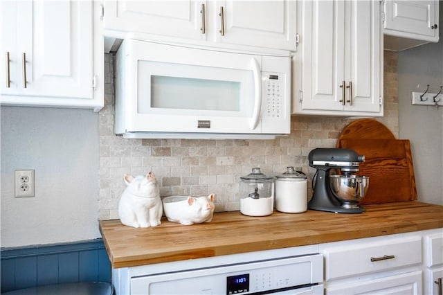 1902 Snowdrop Cir, Liberty, MO 64068 - kitchen featuring white microwave, wood counters, white cabinets, and wainscoting