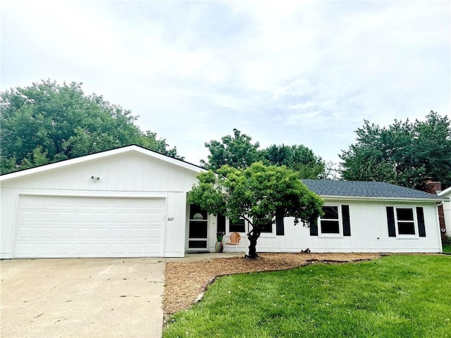 3617 W 24th St, Lawrence, KS 66047 - ranch-style house featuring a front lawn, driveway, a shingled roof, and an attached garage