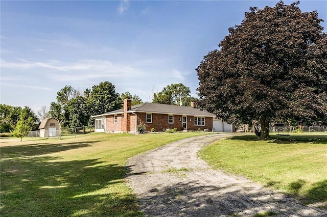 34065 W 135th St, Olathe, KS 66061 - ranch-style home with a chimney, a garage, asphalt driveway, brick siding, and an outdoor structure