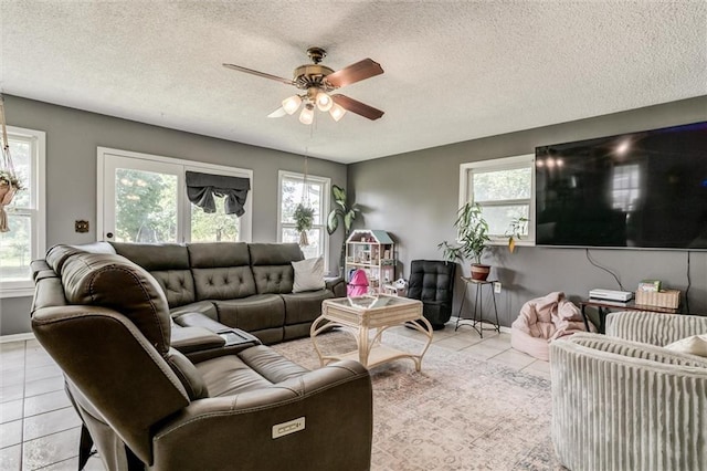 34065 W 135th St, Olathe, KS 66061 - living room with tile patterned floors, a ceiling fan, and a textured ceiling