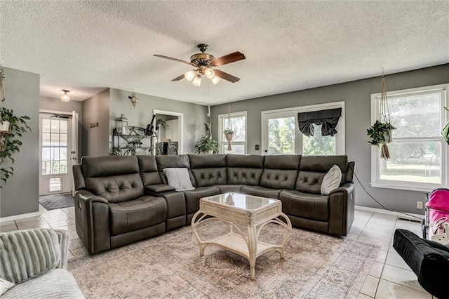 34065 W 135th St, Olathe, KS 66061 - living room with a ceiling fan, a textured ceiling, and light tile patterned flooring