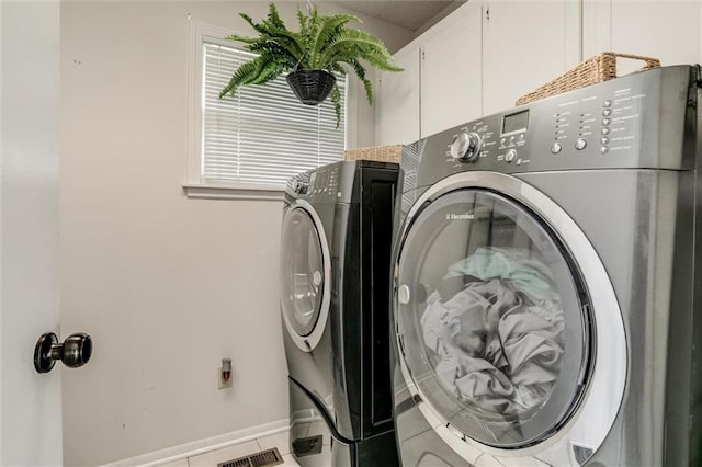34065 W 135th St, Olathe, KS 66061 - laundry room featuring washer and dryer, tile patterned flooring, and cabinet space