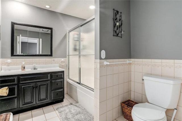34065 W 135th St, Olathe, KS 66061 - full bath featuring tile walls, vanity, tile patterned flooring, wainscoting, and enclosed tub / shower combo
