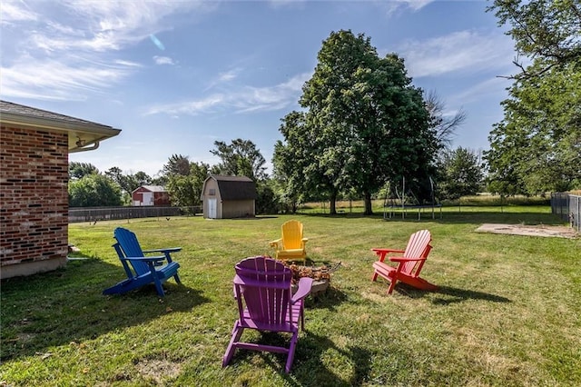 34065 W 135th St, Olathe, KS 66061 - view of yard with a trampoline, a storage unit, and a fire pit