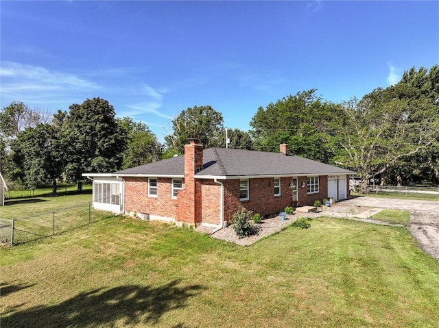34065 W 135th St, Olathe, KS 66061 - view of property exterior with a chimney, brick siding, an attached garage, and driveway