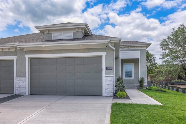 24110 W 95th St, Lenexa, KS 66227 - view of front facade with stucco siding, driveway, a front lawn, stone siding, and a garage